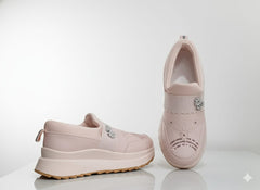 Pair of pink slip-on shoes with decorative elements 
