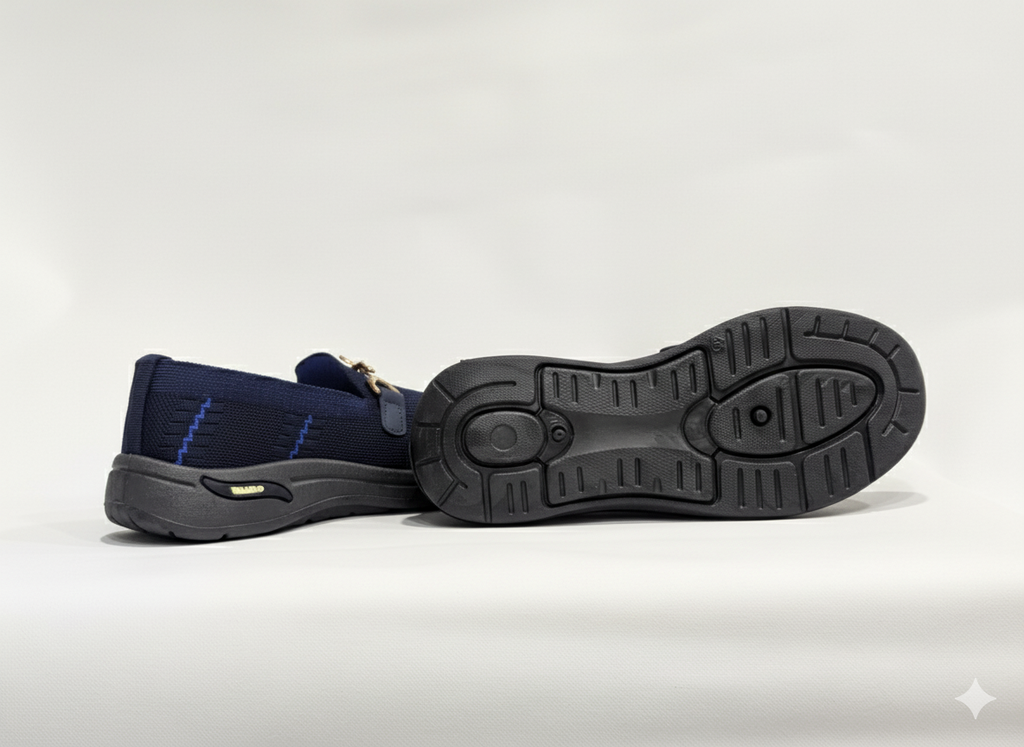 Sole of Pair of Blue loafers with gold accents 