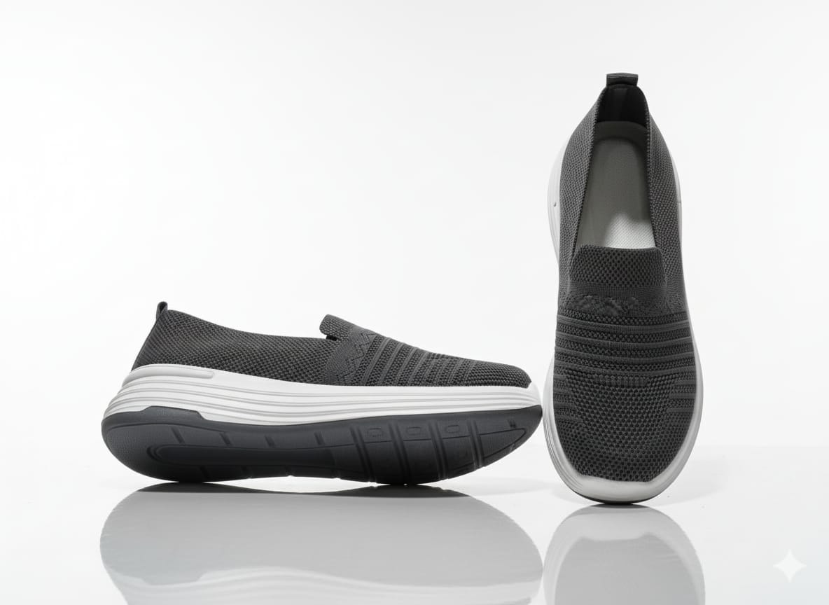 Pair of black slip-on shoes with white soles 